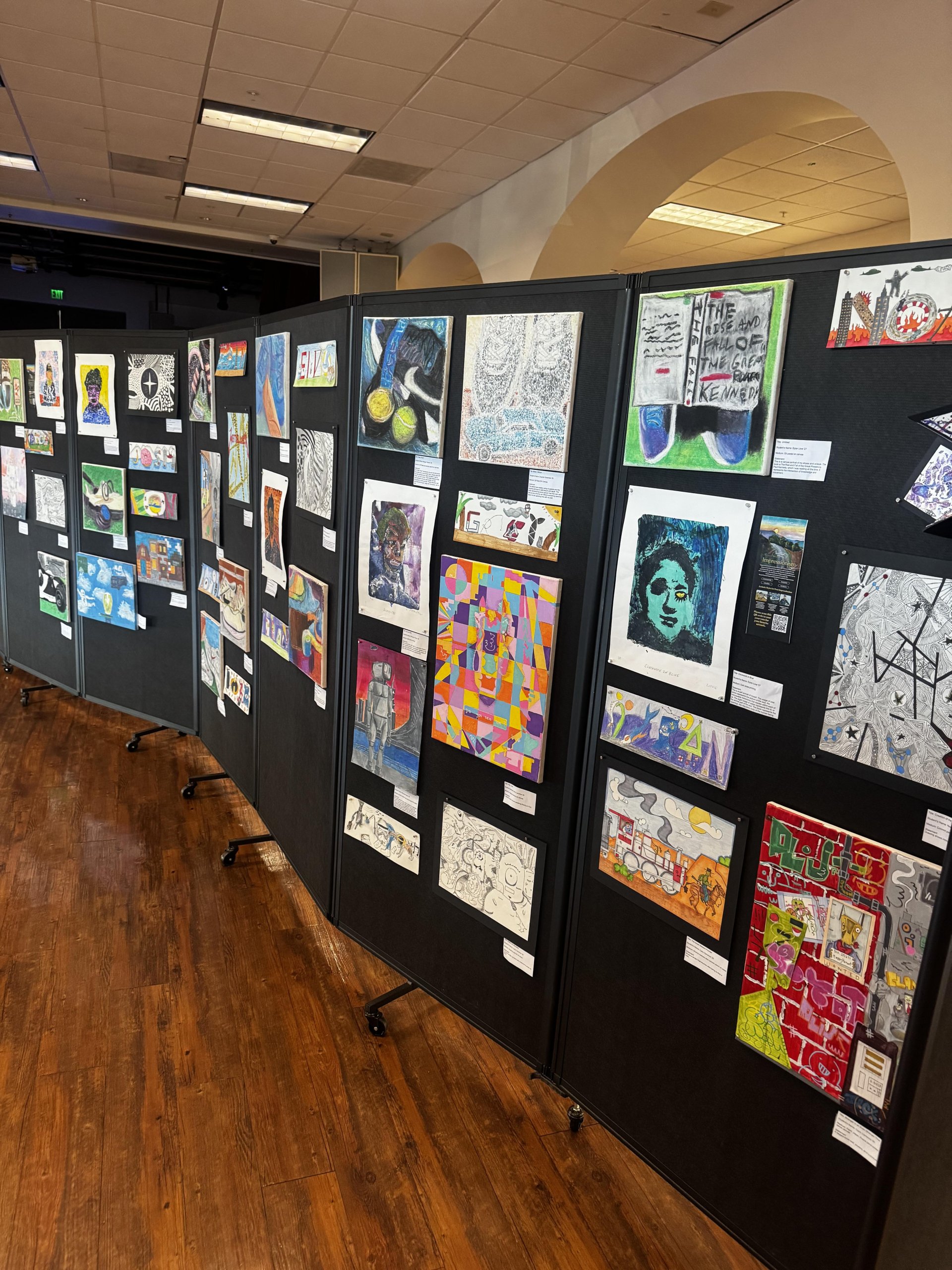 Student artwork displayed throughout the Crespi Fine Art Festival gallery space.