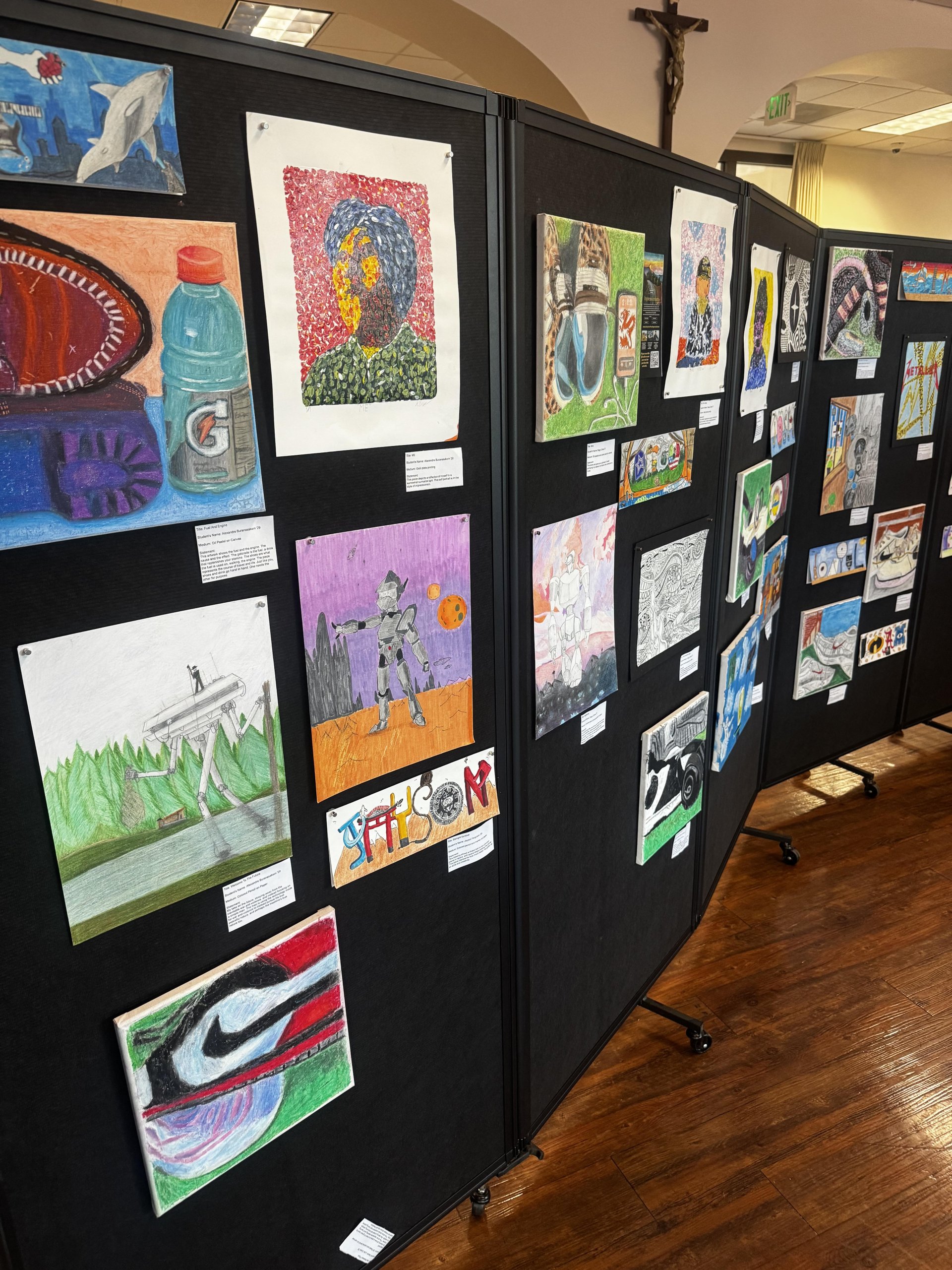 Crespi student artists showcased paintings, drawings, and original compositions across multiple display panels.