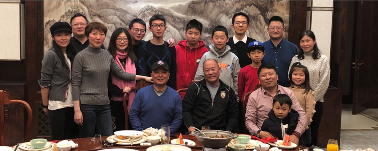 group of international students and families at dinner